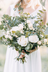 Wedding decor in the design of the arch. Floristry and flowers at sunset.