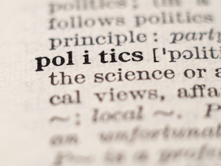 Dictionary definition of word politics, selective focus.