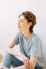  Expressive look of a woman. Portrait of a stylish young girl in the interior Studio.