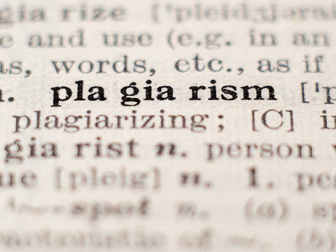 Dictionary definition of word plagiarism, selective focus.