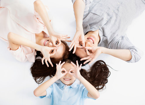 Top view of Happy asian Family lying on the floor