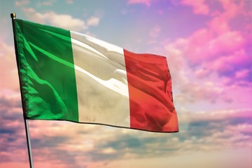 Fluttering Italy flag on colorful cloudy sky background. Prosperity concept.