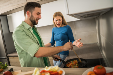 Wife does not like meal that her husband is preparing.