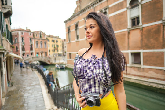 Smiling woman Tourist Takes Photos In Italy