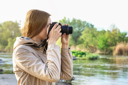 Female tourist taking photo of river