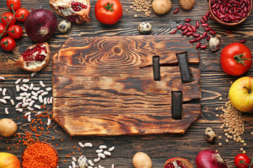 Different healthy food and board on wooden table
