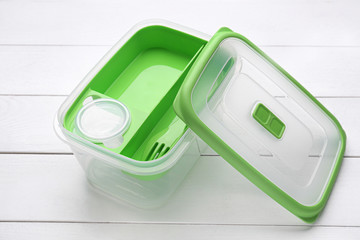 Plastic lunch box on white wooden background