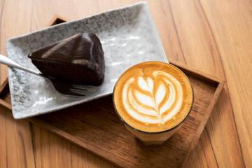 Hot Latte, Latte Art Pattern, Beautiful with cakes on a wooden table