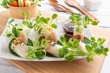 Rice paper salad rolls with carrot,sunflower sprout, corn and crab stick © teen00000