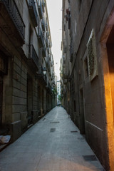 Fototapeta na wymiar Barcelona, Spain - 26th July 2017 - People or tourists walking through a long alley to the shops