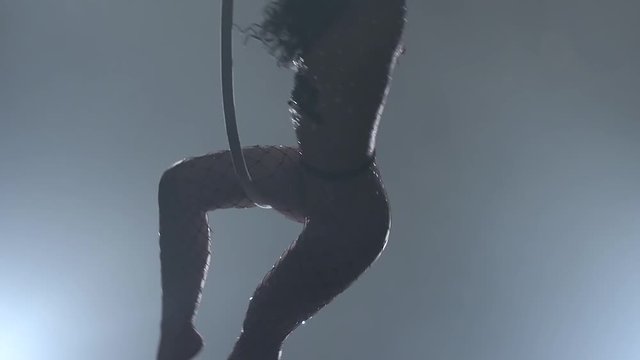 Young girl performs the acrobatic elements in the air ring. Slow motion. Closeup. 206
