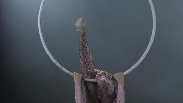 Young girl performs the acrobatic elements in the air ring. Slow motion. Closeup. 208