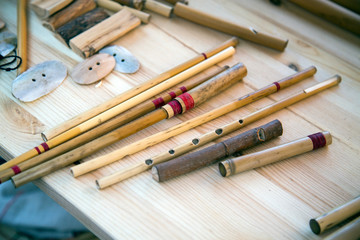 Flute Hornpipe in front of a white Board. Selective focus. Folk wooden musical instruments Leisure Hobbies.