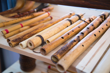 Flute Hornpipe in front of a white Board. Selective focus. Folk wooden musical instruments Leisure Hobbies.