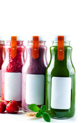 Set with color smothies in glass bottles with copy space on white background, mock-up