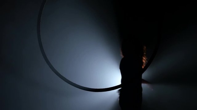 Silhouette Young girl performs the acrobatic elements in the air ring. Slow motion. Closeup. 252