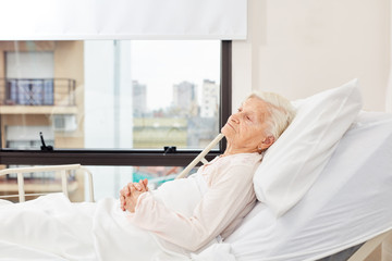 Senior woman is sick in bedside