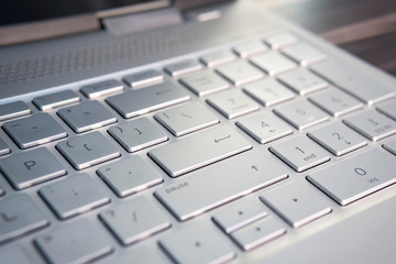 button on the gray silver keyboard of modern ultrabook close up. caption on the button