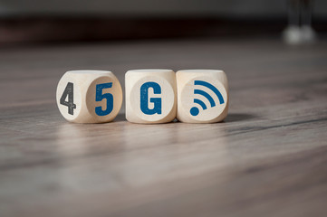 Cubes and dice with 4G and 5G on wooden background