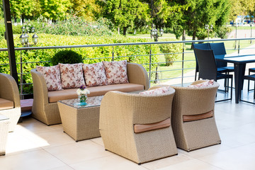 outdoor sofas for relaxing in a cafe outdoor with green park.