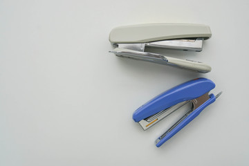 isolated office stationary of big blue and white stapler in workplace for business documents