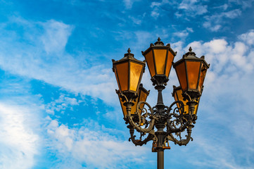 Fototapeta na wymiar Vintage street lamp against blue sky