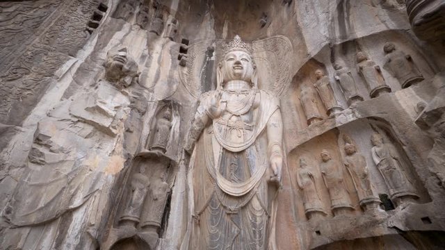 Giant Bodhisattva statue in the famous Longmen Grotto in Luoyang, Henan Province, China.  finest art of stone carving. Statue was dated from China's Tang Dynasty. 