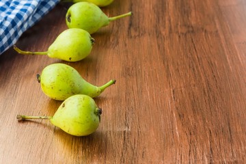 fresh pears in a basket on wooden table