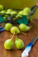 fresh pears in a basket on wooden table