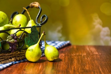 fresh pears in a basket on wooden table