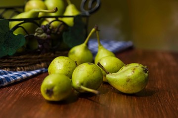 fresh pears in a basket on wooden table
