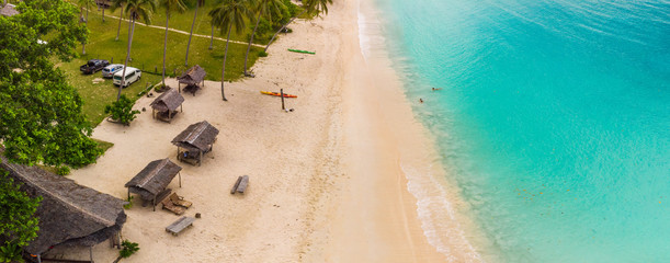 Port Orly sandy beach with palm trees, Espiritu Santo Island, Vanuatu.