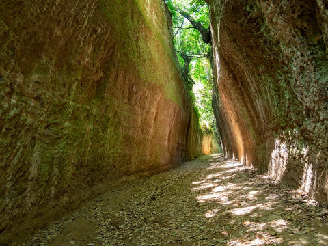 SOVANA, TUSCANY, ITALY - JUNE 16, 2019 - Via Cava, Cave ie deep cut paths created by Etruscan civilisation through tuff rock, Sovana in Maremma, Italy
