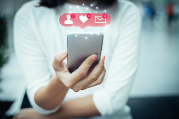 Social media network concept.Female hands holding mobile phone