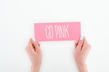 partial view of woman holding pink card with go pink lettering on white background