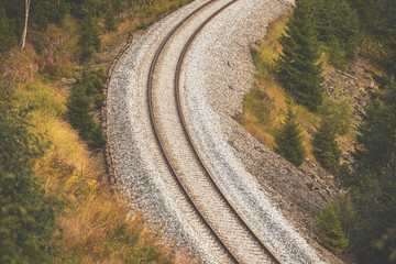 The sharp turn of the railway on the mountainside in the fall. View from above
