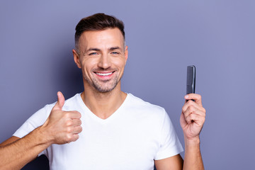 Close up photo amazing he him his middle age macho perfect appearance hands arms plastic hair styling brush good quality use user advising buy buyer wear casual white t-shirt isolated grey background