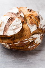 Gold rustic crusty loaves of bread and buns on wooden background. Still life captured from above top view, flat lay.