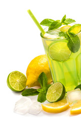 Fruit lemonade in a glass with a straw. Cocktail of lemons and lime with the addition of mint