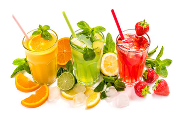 Fruit lemonade in a glass with a straw with ice cubes and mint leaves.  Multicolored fruit cocktails