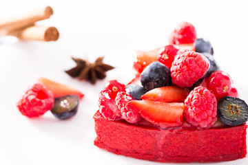 cake with fresh forest berries with cinnamon and anise