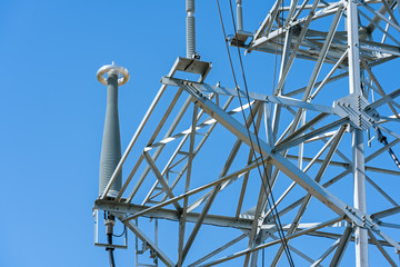 high voltage power line tower sky closeup