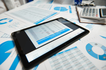 Office workspace for business. Tablet pc and reports. Table closeup. Business financial accounting concept.