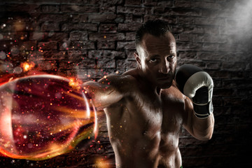 Fototapeta na wymiar Confident athletic boxer with fiery boxing gloves