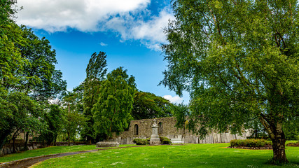 Fototapeta na wymiar Beautiful garden of the Abbey Graveyard with green grass a path in the town of Athlone, wonderful sunny spring day in the county of Westmeath, Ireland