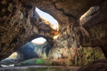 The magic cave / Magnificent view of the Devetaki cave, one of the largest and most picturesque caves in Bulgaria - obrazy, fototapety, plakaty