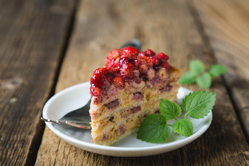 A piece of homemade cake with fresh strawberries