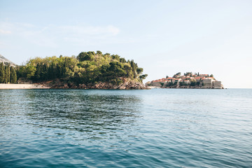 Fototapeta na wymiar Beautiful view of the island of Sveti Stefan or Saint Stephen in Montenegro. One of the famous sights of Montenegro.