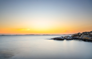 a colorful sunset at the cliffs of Smögen in Sweden
