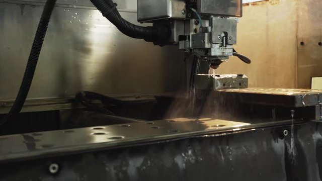 Electrical discharge machine manufacturing process shapes metal by create sparks